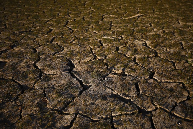 Storms take aim at large wildfires in South