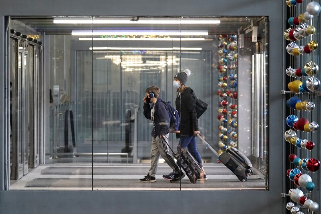 Holiday air travel surges despite dire health warnings