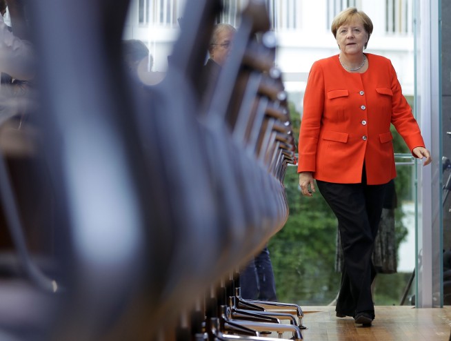 The Latest: Merkel open to idea of new eurozone minister