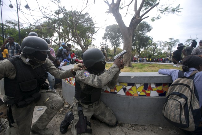 Haiti police exchange fire with troops near national palace