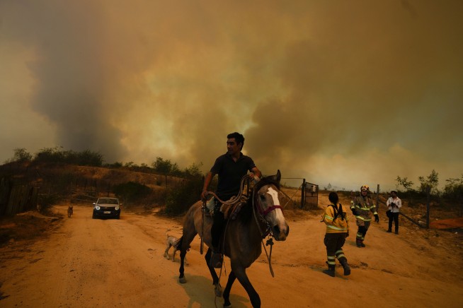 Chile accuses volunteer firefighter and ex-forestry official with causing huge fire that killed 137