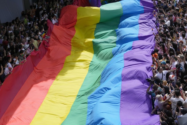 Lawmakers in Thailand overwhelmingly approve a bill to legalize same-sex marriage