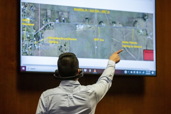 Iowa murder suspect blames mystery men for runner's slaying