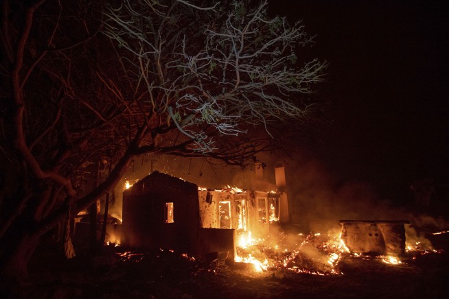 New wildfires sweep through California, burning homes