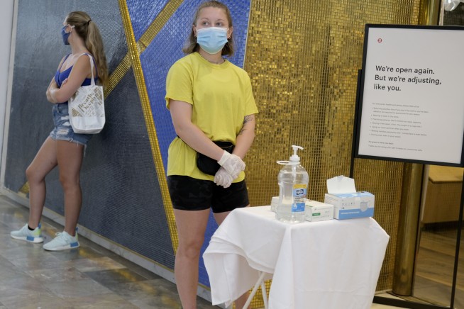 States reverse openings, require masks amid virus resurgence