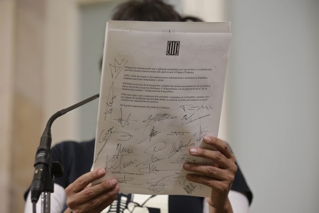 Catalan leader stakes claim to independence, then delays it