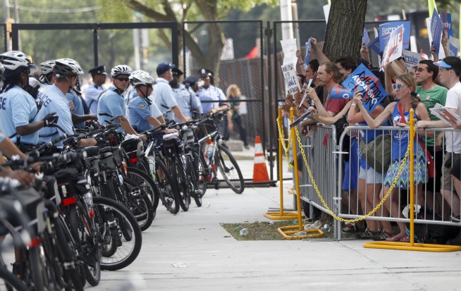 Pro-Sanders demonstrators march in the sweltering heat