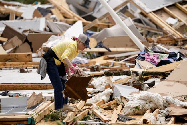 Storm-battered South is again under threat. A boy swept into a drain fights for his life