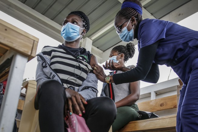 The Latest: CDC: No masks for vaccinated teachers, students