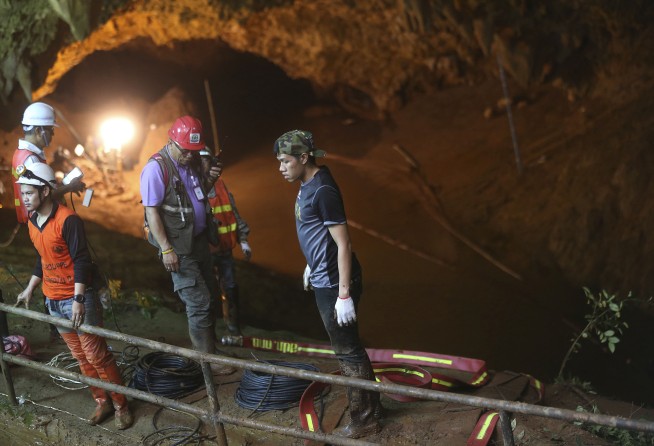 Thai rescuers search for other entrances to flooded cave