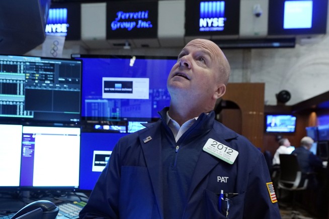 Stocks rise after Fed says it will dial back aid for economy