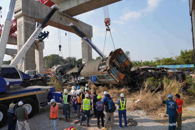 A construction crane falls onto a moving train in Thailand, killing at least 32 people