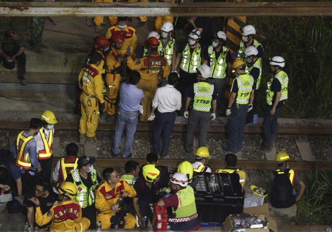 Train hits truck that slid onto track in Taiwan, killing 51