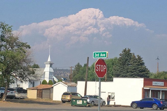 California fire prompts evacuations; Oregon blaze balloons