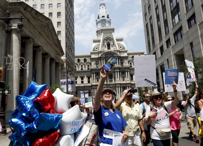 Pro-Sanders demonstrators march in the sweltering heat