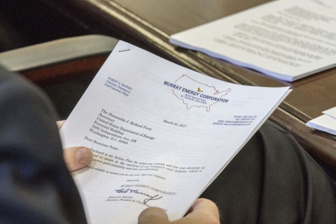 DOE staffer claims retaliation over photos of secret meeting