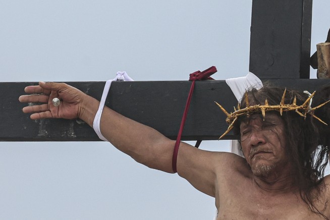 A Filipino villager is nailed to a cross for the 35th time on Good Friday to pray for world peace