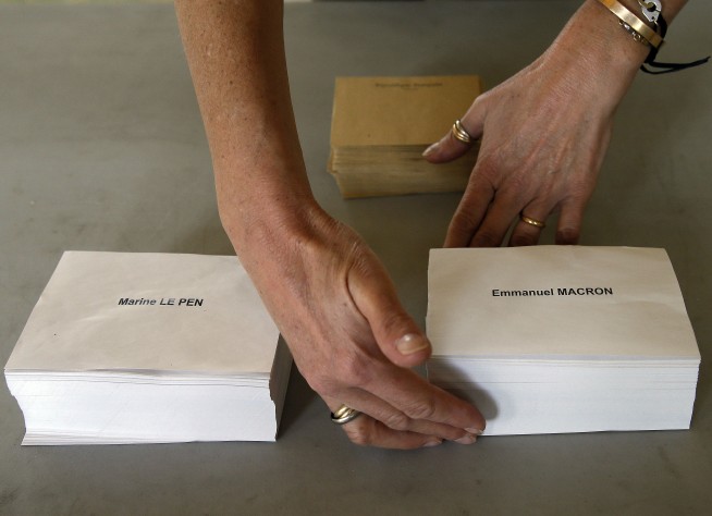 The Latest: Macron's team says it suffered 'massive' hack