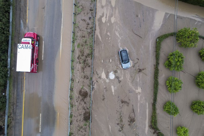 Landslides, sinkholes, floodwaters plague soggy California