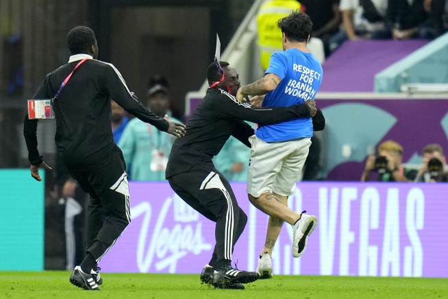 Protester with rainbow flag runs onto field at World Cup