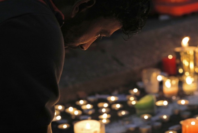 The Latest: Police search homes of suspect's mother, sister