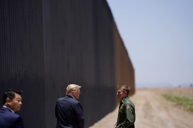 As virus surges, Trump turns attention to border wall