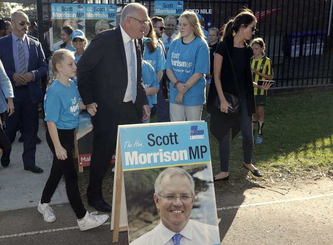 Australia's ruling coalition elected to surprise third term