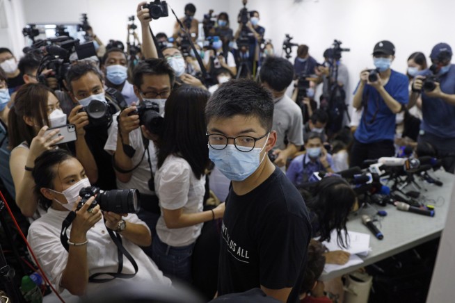 Hong Kong postpones elections by a year, citing coronavirus
