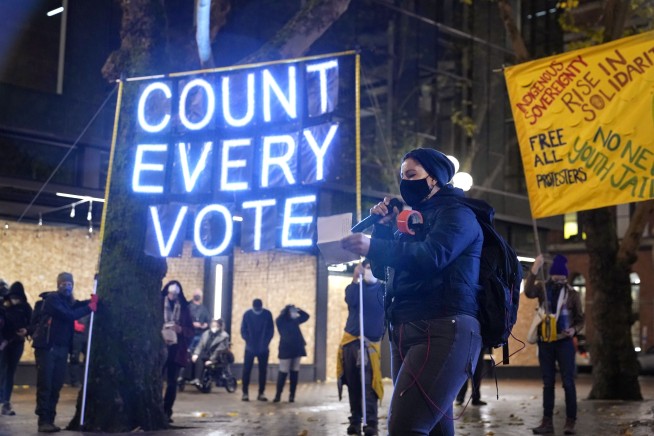 Trump backers converge on vote centers in Michigan, Arizona