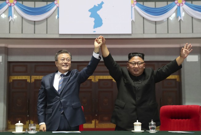 Kim, Moon join hands on peak of sacred North Korean volcano