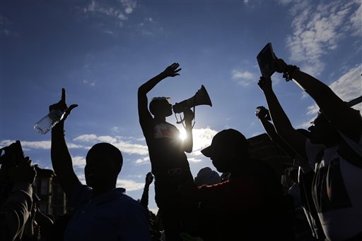 Baltimore relieved by charges, weary of curfew