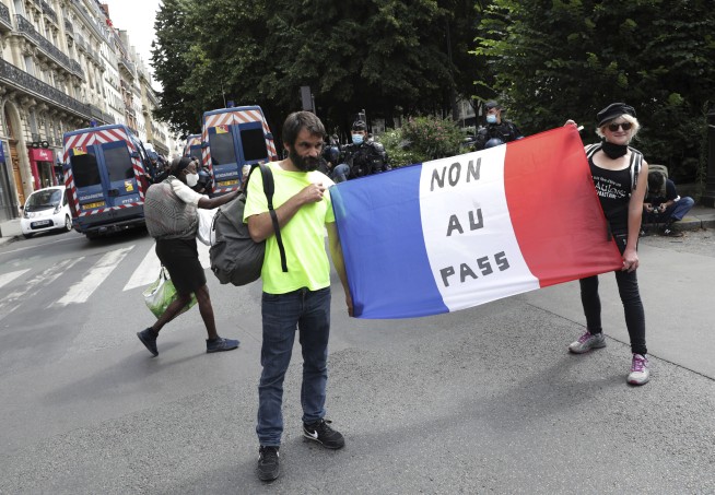 French police clash with anti-virus pass protesters in Paris