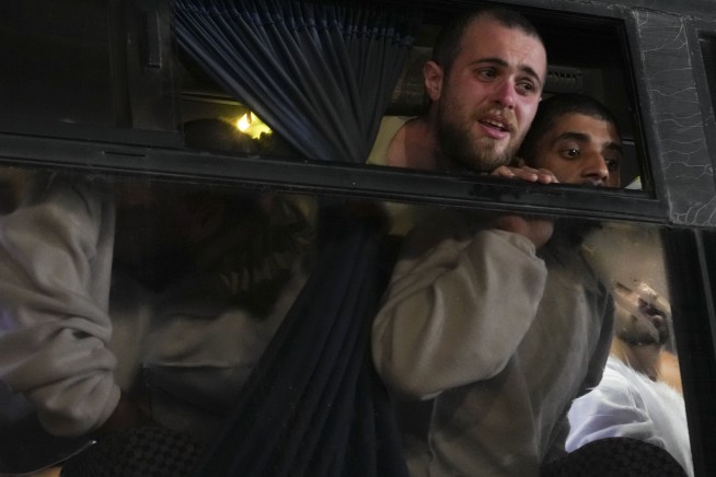 Hamas hands over bodies of 4 hostages to Israel as dozens of Palestinians leave Israeli prison