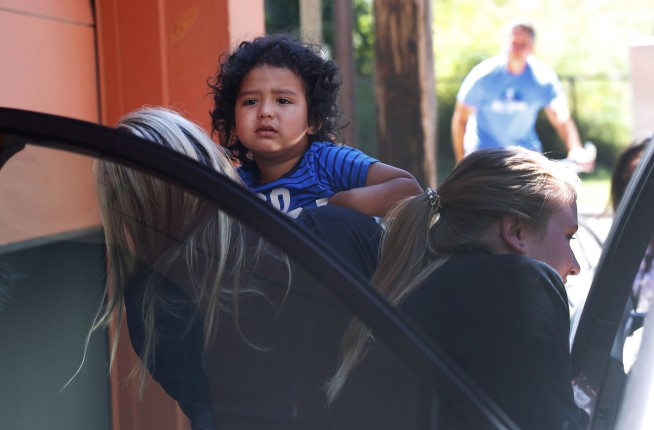 Reunited immigrant children scooped up into parents' arms