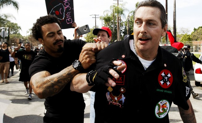 The Latest: 13 in custody after violence at KKK gathering