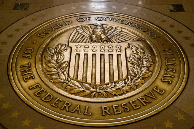 Fed keeps rate near zero but sees brighter economy in 2021