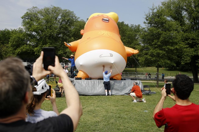 The Latest: Protesters show off diapered baby Trump balloon