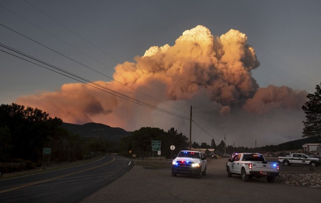 New Mexico wildfire threatening village doubles in size