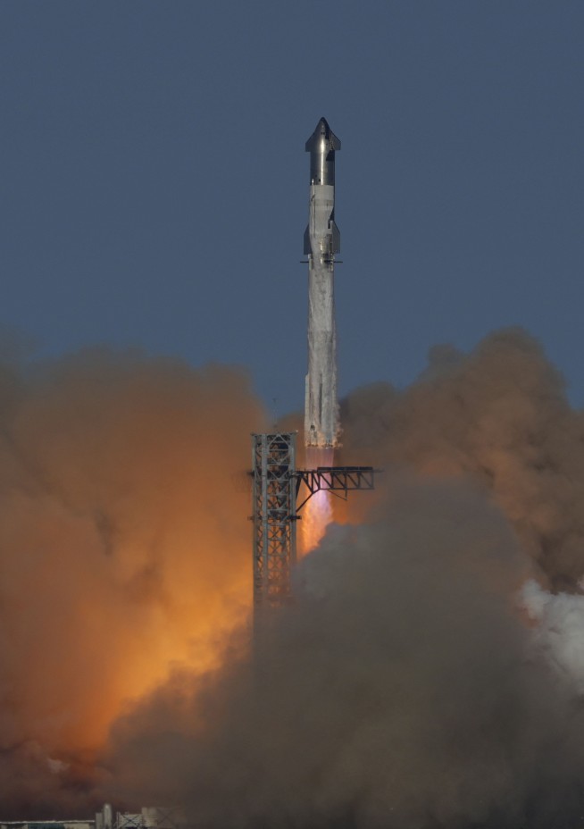 SpaceX launches giant Starship rocket, but aborts attempt to catch booster with mechanical arms