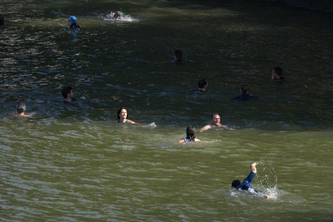 Paris mayor dips into the Seine River to showcase its improved cleanliness before Olympic events