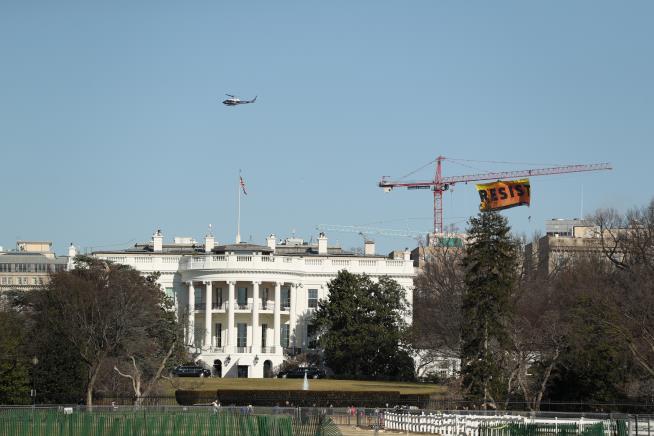 Protesters Lift 'RESIST' Banner From Crane Near White House