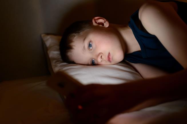 Kid Glued to His Phone? His Sleep May Not Suffer (Much)