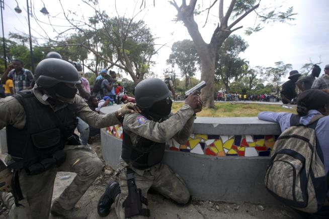 Haiti Police Exchange Fire With Troops