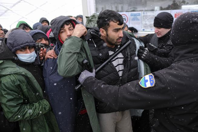 Snow Falls on Migrants Stuck in Burned-Out Tent Camp