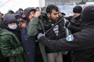 Snow Falls on Migrants Stuck in Burned-Out Tent Camp
