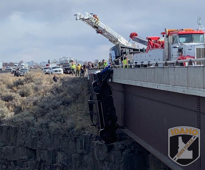 Truck Dangles Over Gorge— With 2 Inside