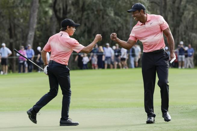 Tiger Woods Caddies for Son at Golf Tournament