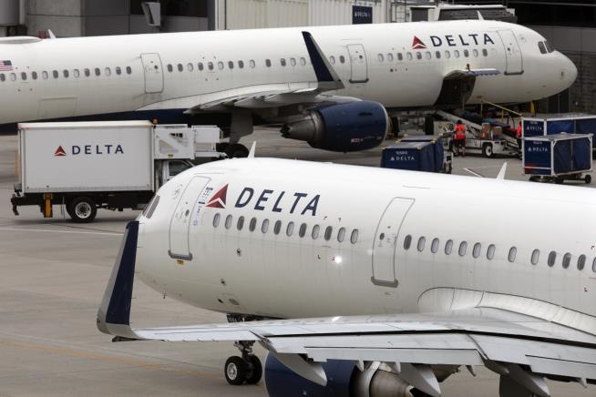 Passengers Exit on Slides After Aborted Delta Takeoff