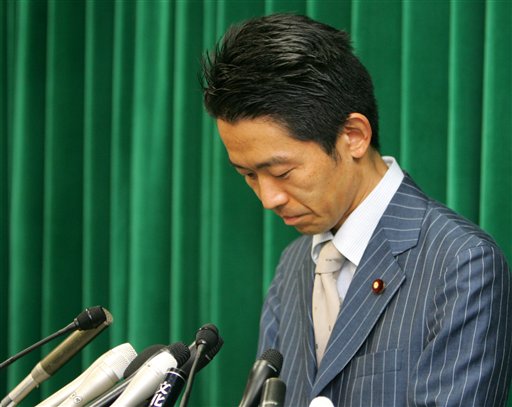 Japanese PM Axes Minister, Clings to Job