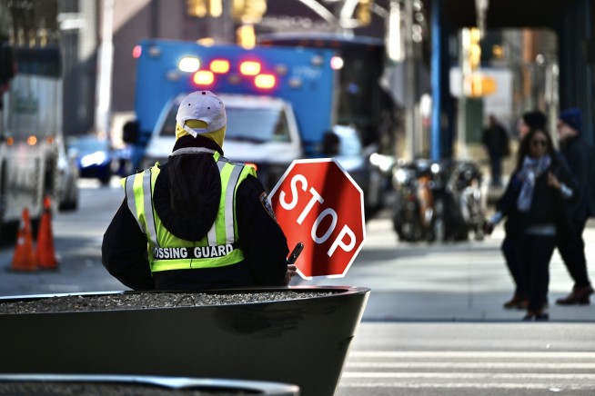 Boy Stopped by Flooded Street Gets a Lift From Crossing Guard